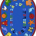 An oval blue educational kids rug with the Hebrew alphabet and animals around the edge.