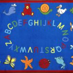 A blue rectangle kids rug with animals and alphabet around the edge.
