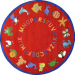 A red round kids rug with animals and alphabet around the edge.