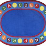 An educational baby rug with the alphabet inside circles around the edge.