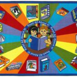 A childrens rug with an image of two kids reading the same book. The rug has different colors and books around the edge.