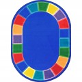 An oval classroom seating rug with different colored squares around the edge.
