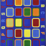 An educational rug with multi-colored squares and alphabet around the edge.