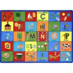 A rectangle educational kids rug with the english alphabet and spanish words.